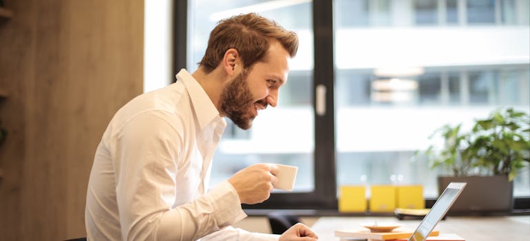 A man watching a video on a laptop about the potential of commercial storage.