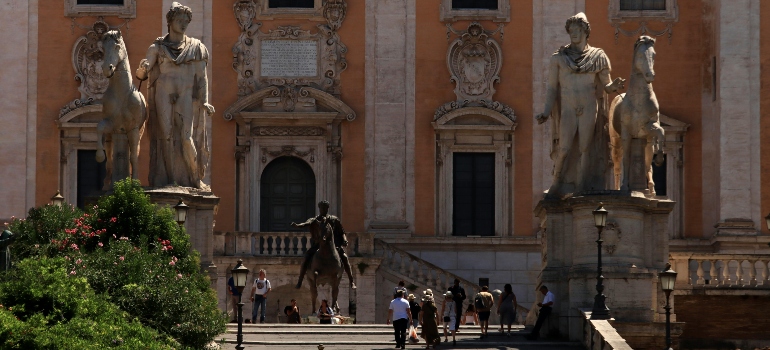 Captivating sculptures in a historic Italian square, inviting thoughts of moving to Italy after holidays.